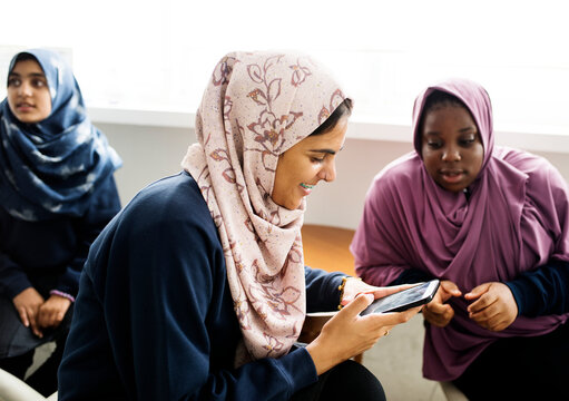 Group of Muslim students using a smartphone