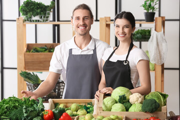 Young sellers with fresh vegetables in market