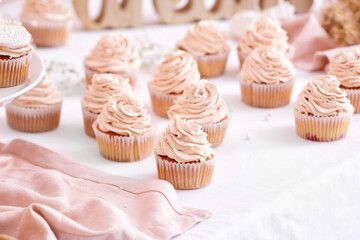Tasty wedding cupcakes on table