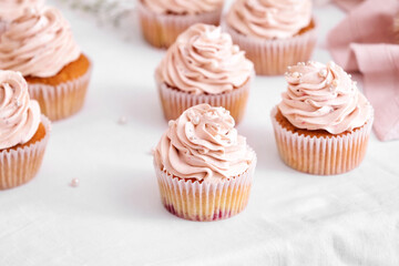 Tasty wedding cupcakes on table