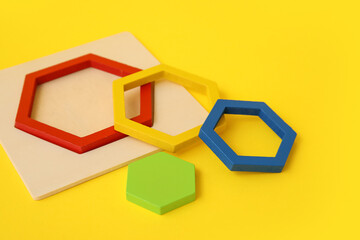 Wooden toy on color background