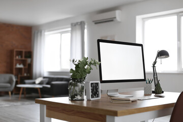 Workplace with modern computer in room