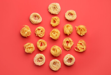 Different types of uncooked pasta on color background