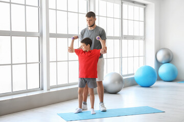 Physiotherapist working with boy in rehabilitation center