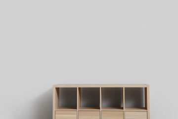 Empty wooden TV stand near light wall