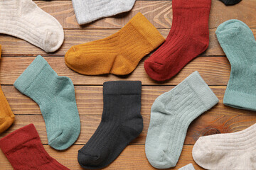 Different baby socks on wooden background, closeup