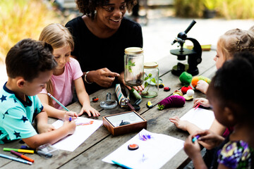 Group of kids classmates learning biology drawing class
