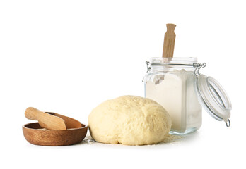 Fresh dough, dry yeast and glass jar with flour on white background