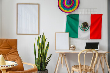 Interior of stylish room with workplace and Mexican flag