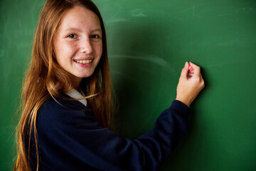 Female student writing on whiteboard
