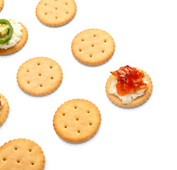 Delicious crackers with cottage cheese and jalapeno pepper jam on white background