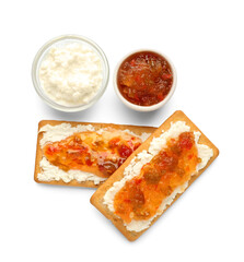 Delicious crackers with cottage cheese and jalapeno pepper jam on white background