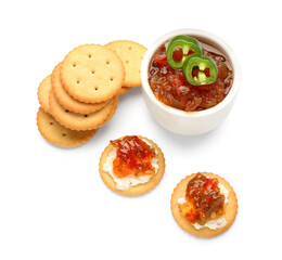 Delicious crackers with cottage cheese and jalapeno pepper jam on white background