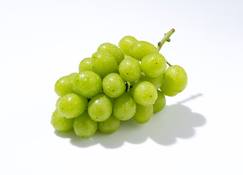 Shine Muscat grapes on a white background.