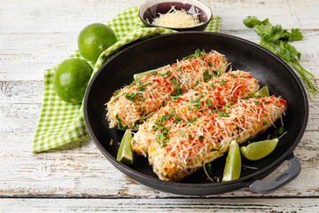 Frying pan with tasty Elote Mexican Street Corn on white wooden background
