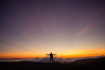 Fototapeta na wymiar silhouette of a cross in the mountains