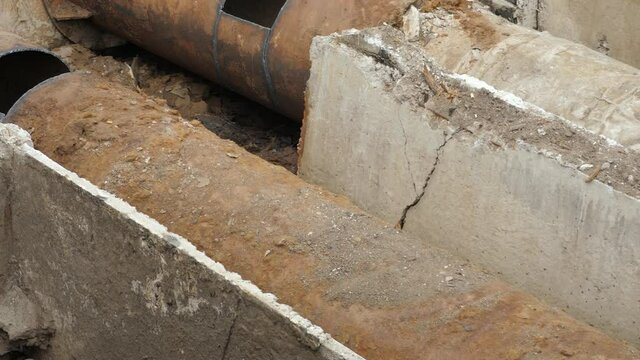 Laying district heating pipeline. Insulated steel pipe in deep trench. Water infrastructure development. Insulated pipes used for district heating and hot water supply