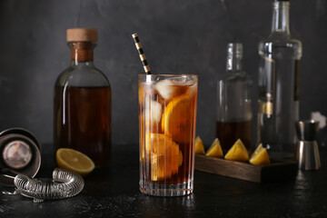 Glass of tasty Long Island iced tea on dark background