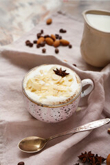 Cup of tasty almond latte on grunge background