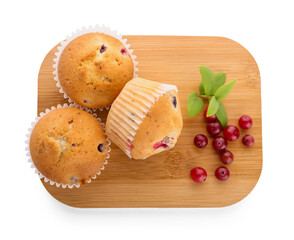 Wooden board with tasty cranberry muffins on white background
