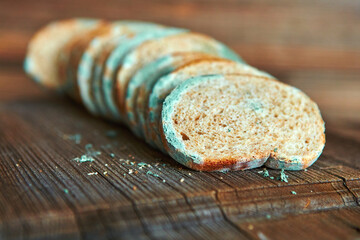 Stale, moldy pieces of stale bread. Mold on sliced bread with harmful bacteria. Fungal mold has...