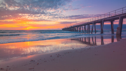 Port Noarlunga jetty with people during pink sunset, South Australia