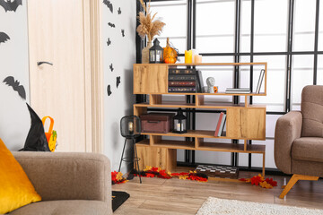 Wooden book shelf in room decorated for Halloween