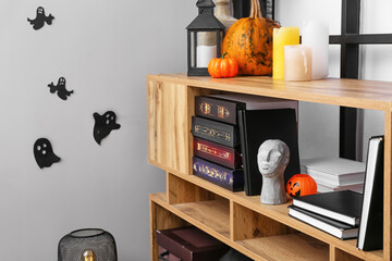 Wooden book shelf in room decorated for Halloween © Pixel-Shot