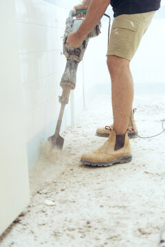 Workman jackhammering on construction site