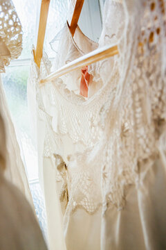 Lace dresses hanging in a window