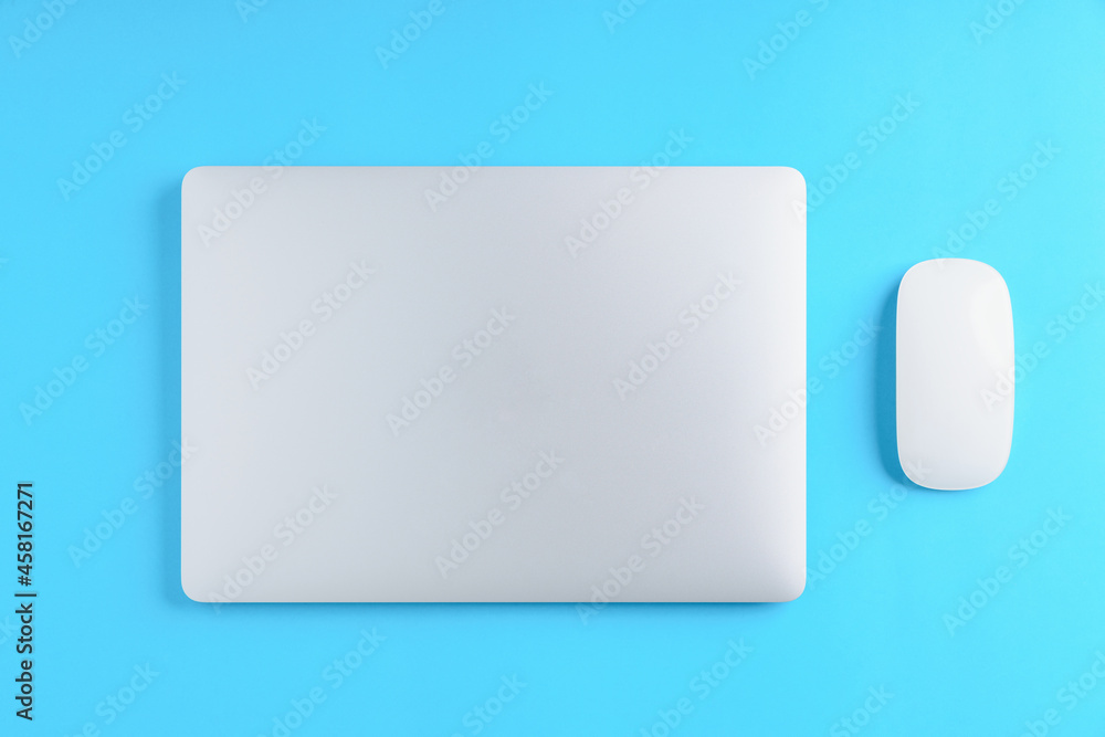 Poster laptop computer and mouse on blue background above view