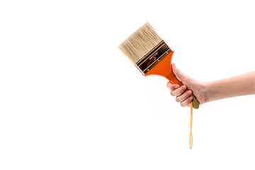 Close up human hand holding a paint brush isolated on white background.