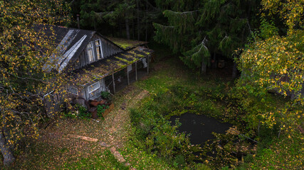 Abandoned forester's house in a deep forest. Autumn forest landscape. An aging abandoned house.