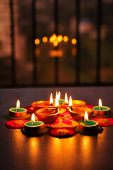 Diwali celebration Indian festival of lights Diya oil lamp and colors Rangoli decoration bright colorful  flowers flowerbed copy space greetings Dipavali Hindu festival North India, Mumbai Delhi India © sanirimpan