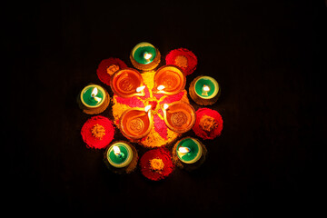 Diwali celebration Indian festival of lights Diya oil lamp and colors Rangoli decoration bright colorful  flowers flowerbed copy space greetings Dipavali Hindu festival North India, Mumbai Delhi India