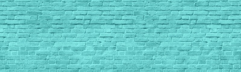 Light teal old shabby brick wall wide panoramic texture. Turquoise painted rough brickwork panorama. Pastel blue abstract widescreen background