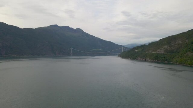Aerial shot flying towards Hardanger suspension bridge and fjord in Norway