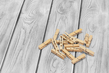 Set of wooden clothes pins on wooden background