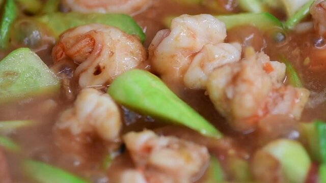 Shrimp and cucumber simmering in sweet and sour tomato sauce
