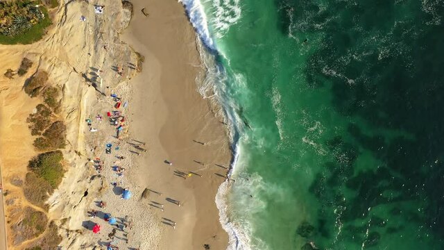 Top down aerial of San Diego, La Jolla beach, with people and surfers