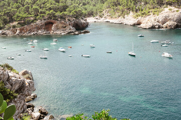 Fototapeta na wymiar Beautiful beach with very clean and azure water on the mediterranean sea in the island of Ibiza, Spain