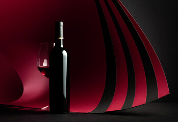 Bottle and glass of red wine.