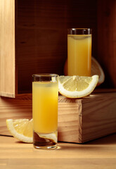 Traditional homemade lemon liqueur limoncello and fresh citrus.