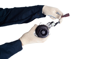 An auto mechanic holds a faulty car cooling system pump that drives coolant, white background, isolate. Regulations for replacing the auto pump