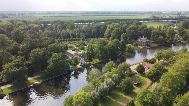 Aerial drone view of the river Nes Stichtse Vecht between Amsterdam and Utrecht with historic houses villa, along the water.