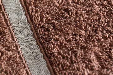 Brown terry towel, background, close-up. handicrafts