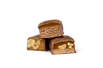Three types of chocolate sweets with nougat, caramel and nuts.