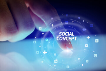 Finger touching tablet with social media icons concept