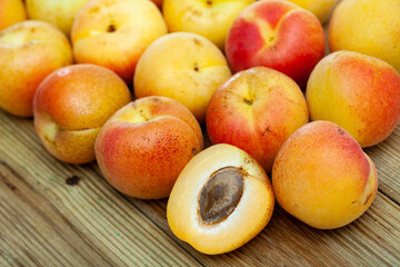 Naklejka na ściany i meble Apricots fruit on wooden table closeup. Vitamin fruits