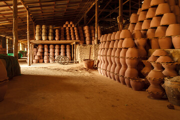 Stacks of terracotta pots in the warehouse.